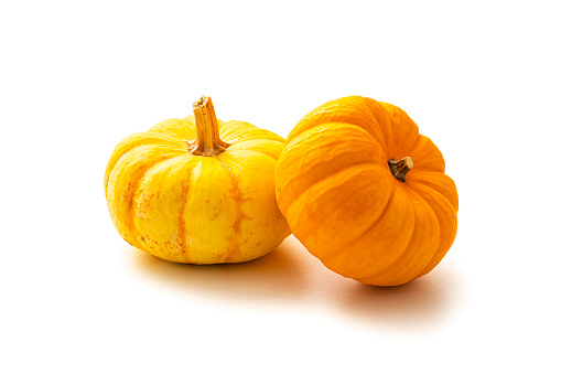 Two small pumpkins isolated on white background. High resolution 42Mp studio digital capture taken with Sony A7rII and Sony FE 90mm f2.8 macro G OSS lens