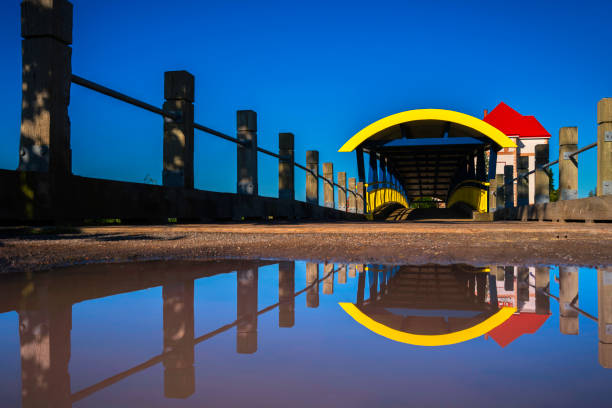 Moncton Bridge over the Petitcodiac River and Water Reflections at the Riverfront Park in New Brunswick, Canada
