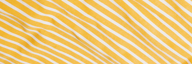 istock Beautiful yellow fabric with white stripes background. Draped background of fabric, texture 1618531920