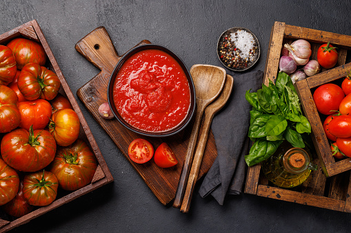 Rich homemade tomato sauce and ingredients. Flat lay