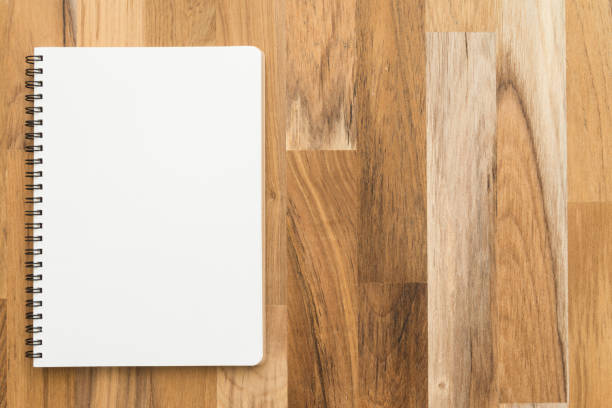 istock Flat lay of open blank spiral notepad or notebook on wooden table background. 1618533000