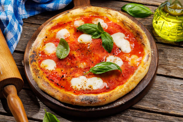 istock Margarita pizza with tomatoes, mozzarella cheese and basil 1618537984
