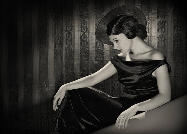 Diva with the hat in film noir style. Emulations of vintage style photography. film noir style photos stock pictures, royalty-free photos & images