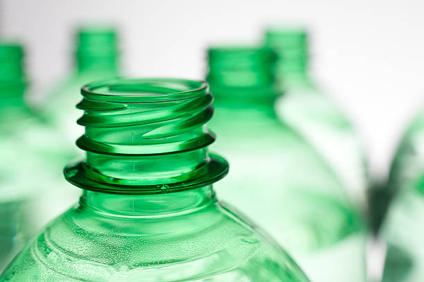 Unique, random and artistic display decorative background with various sizes green glass bottles. Suitable for interior design decoration
