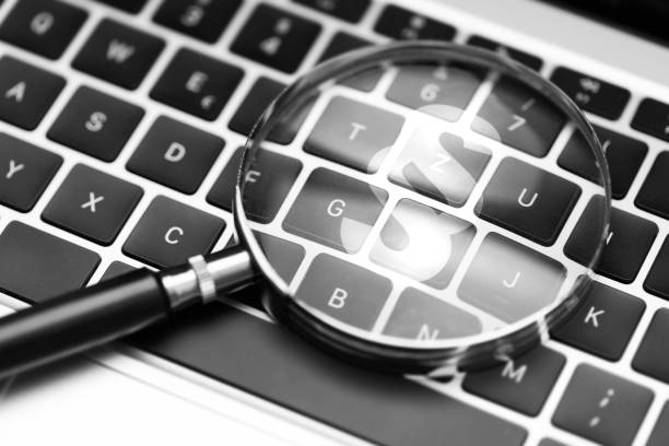 istock Magnifying glass on computer keyboard shows a large paragraph symbol 1618548433