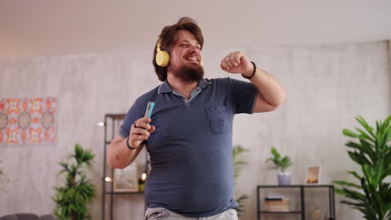 Young Man Singing And Dancing At Home