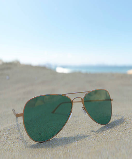 istock Sunglasses on a beach in bright sun 3d render 1618587380
