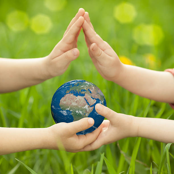 istock Earth in children`s hands 161859569