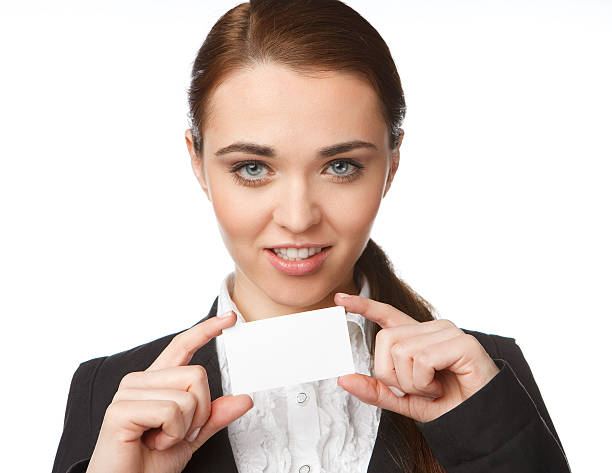Young woman holding a business card on the white background stock photo