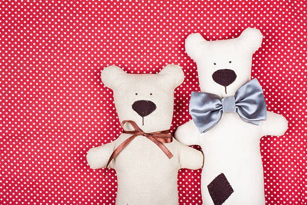 istock Handmade pair of bears on red textile texture background 161860152