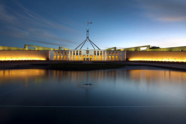 Panoramic shoot of the Parliament in the evening Parliament house Canberra at sunset with flag flying canberra photos stock pictures, royalty-free photos & images