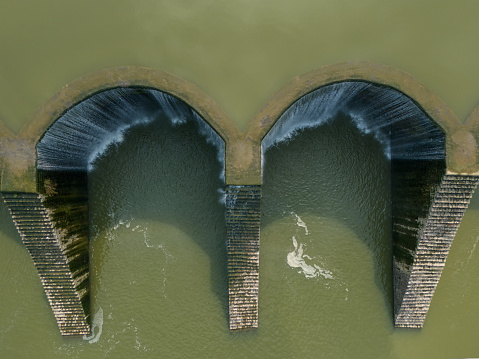 Aerial photo of water overflowing the reservoir dam