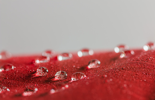 Rain  Water droplets on  a  red waterproof fabric