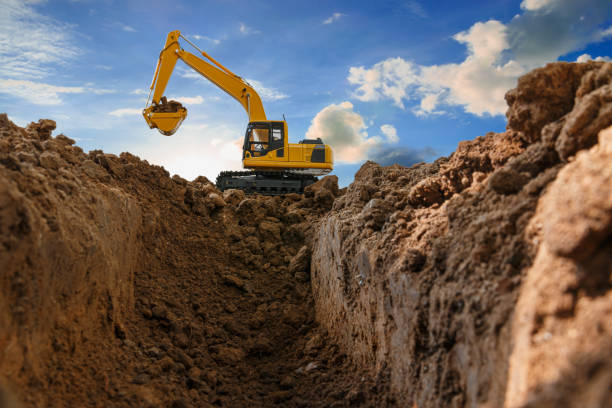 istock Yellow excavators are digging the soil in the construction site 1618657466