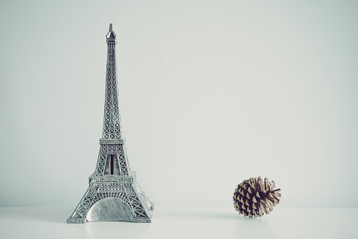 Eiffel tower model on table white wall background copy space. Travel, design decoration concept.