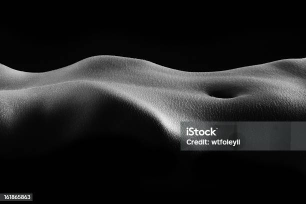 Dimly Lit Closeup Of A Human Torso Laying Horizontally Stock Photo - Download Image Now