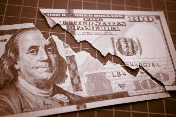 Tear off US dollar bill banknote as chart graph falling down. Tear off US dollar bill banknote as chart graph falling down. The Federal Reserve ( FED ) increase % interest rates to fix inflation crisis. World global economy recession and stagflation concept. collapsing stock pictures, royalty-free photos & images