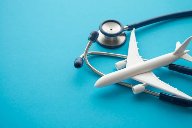 istock Airplane and stethoscope on blue background with copy space. 1618674316