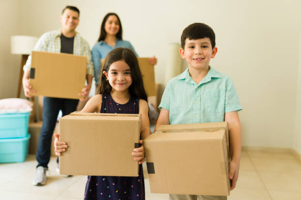istock Beautiful children helping unpack boxes in their new home 1618678230