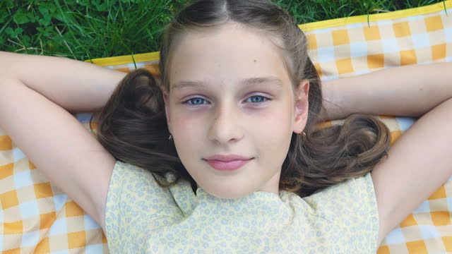 Teenage  girl lying on a grass in park