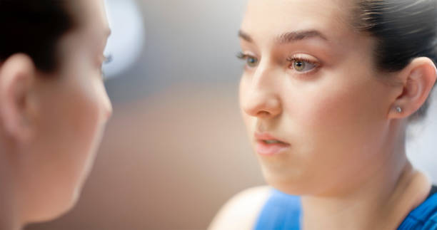 istock Woman looking in mirror 1618747135