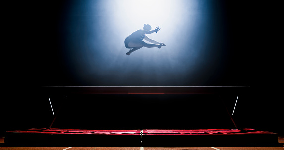 Gymnast woman performing on balance beam