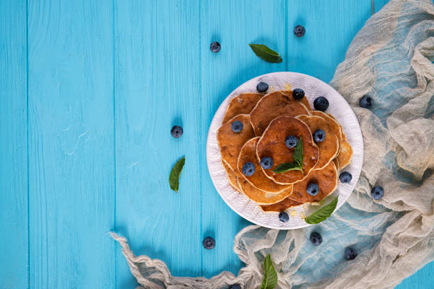 Pancakes with honey and blueberries. Sweet homemade pancakes
