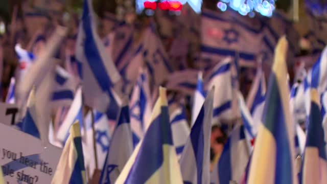 Waving Israeli flags in a demonstration