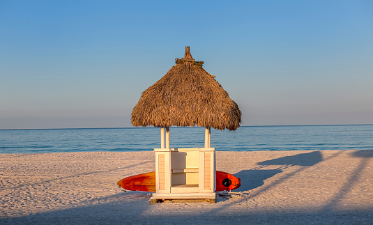 lifeguard hut with surfboard on empty beach at dawn, Florida USA