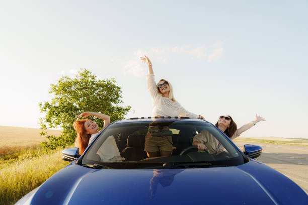 istock Cheerful women excited about vacations while driving car 1618806010