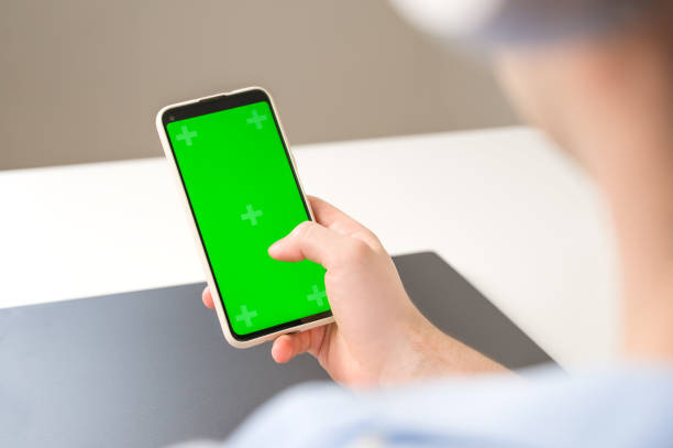 istock Un recognizable man using Smartphone with Green Chroma Key Screen. Mockup. Modern tecnologies,online shopping,social media applications etc 1618812438