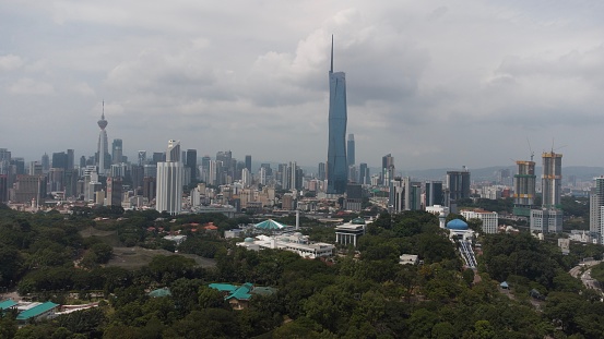 Taken with a drone, this midday shot of Kuala Lumpur's skyline reveals the city's architectural prowess under the brilliant light. The soaring skyscrapers and bustling streets showcase a dynamic urban landscape from a unique and breathtaking perspective.