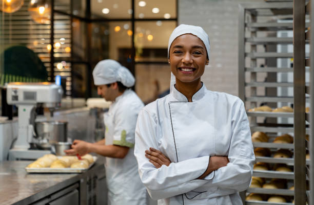 istock Happy female baker working at a pastry shop 1618826210