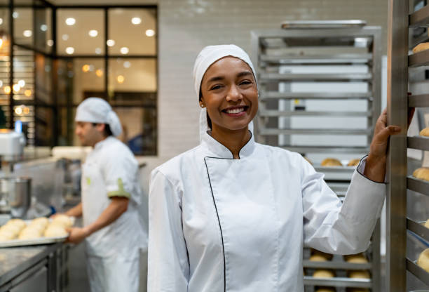 istock Happy woman working at a bakery 1618826214