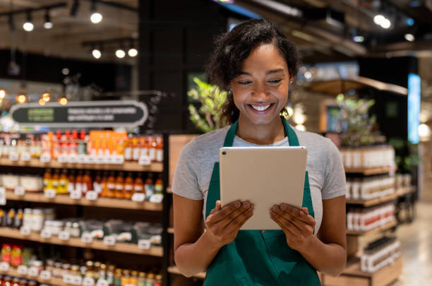 istock Retail clerk working at a supermarket using a digital tablet 1618826805