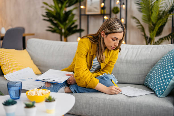 istock Young Woman Checking Her Finances At Home 1618837856