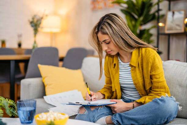 istock Young Woman Checking Her Finances At Home 1618838394