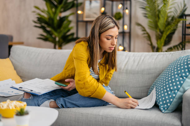 istock Young Woman Checking Her Finances At Home 1618843534