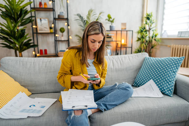 istock Young Woman Checking Her Finances Using Smartphone 1618844118