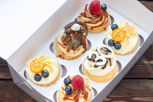 istock Festive cupcakes in cardboard box with berries for a 30 birthday anniversary 1618846413