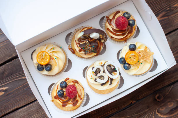 istock Festive cupcakes in cardboard box with berries for a 30 birthday anniversary 1618846414