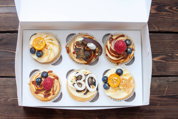 istock Festive cupcakes in cardboard box with berries for a 30 birthday anniversary 1618846418