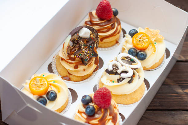 istock Festive cupcakes in cardboard box with berries for a 30 birthday anniversary 1618846423