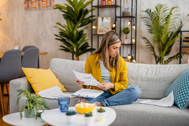 istock Young Woman Checking Her Finances At Home 1618849600