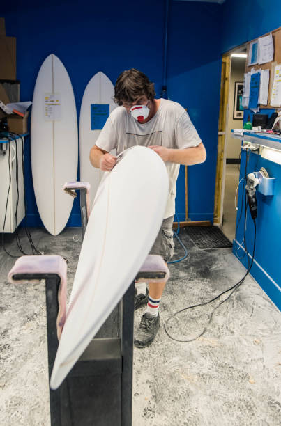 istock Professional surf shaper in action in his studio 1618856089
