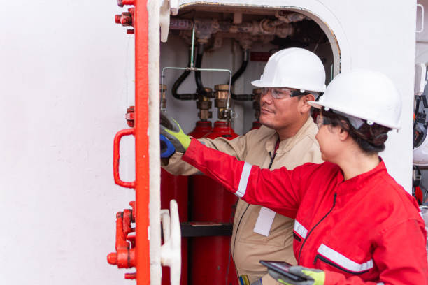 istock Production overhaul: engineers using a digital device to overhaul the industrial machine 1618856632