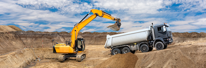 excavator is working and digging at construction site