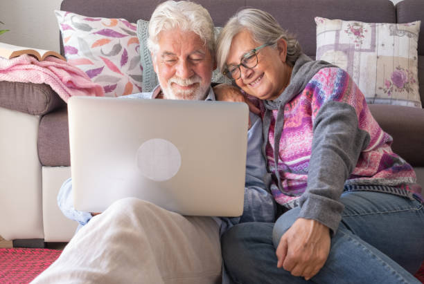 istock Attractive senior couple at home using together same laptop. Smiling elderly retiree enjoying free time,  technology and social media 1618871218