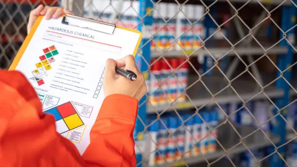 Photo of Checking on the hazardous chemical material information form.