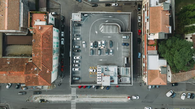 Aerial time lapse of a rooftop parking in the city